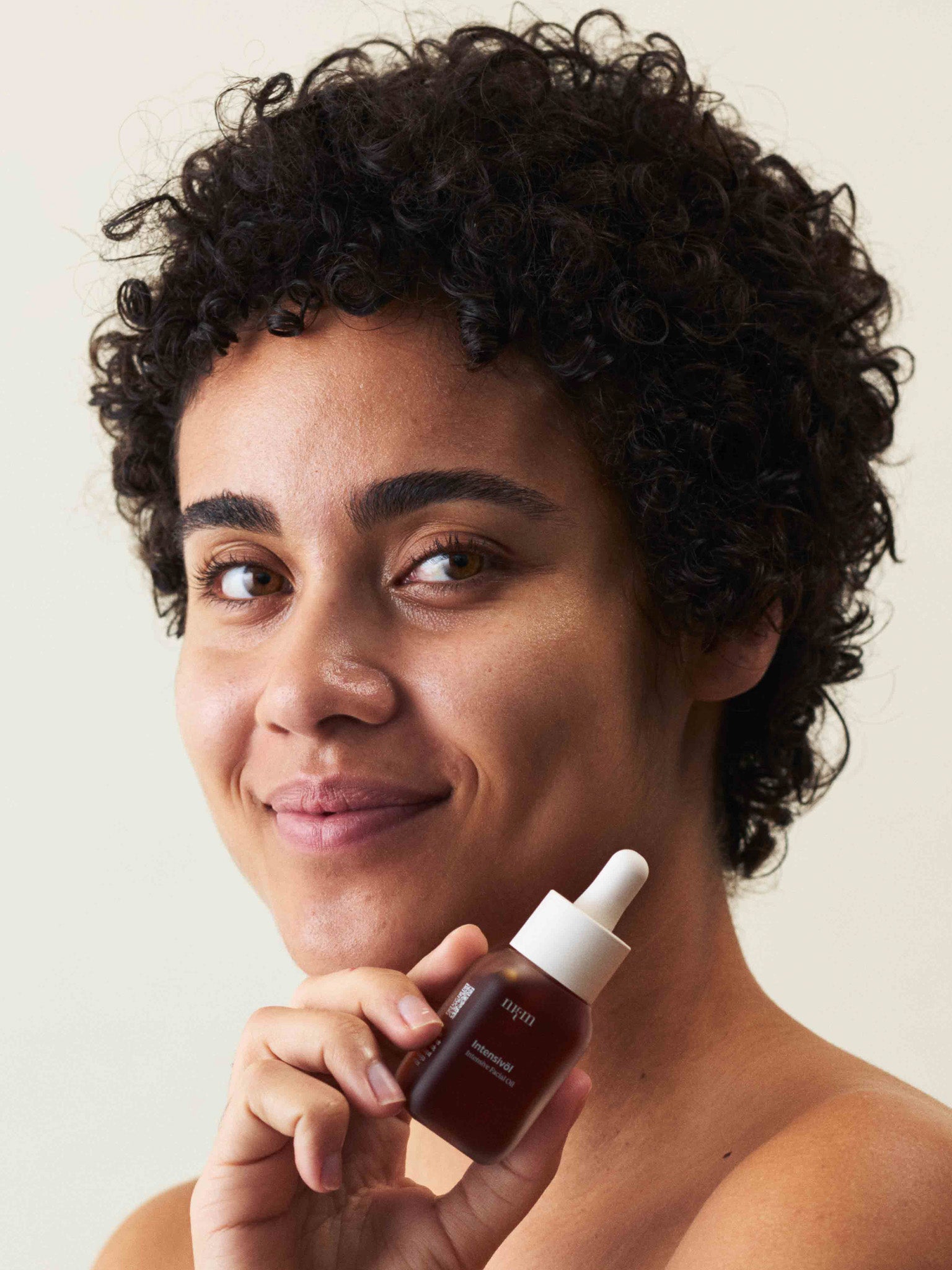 Eine Frau, die das Intensivöl in der Hand hält