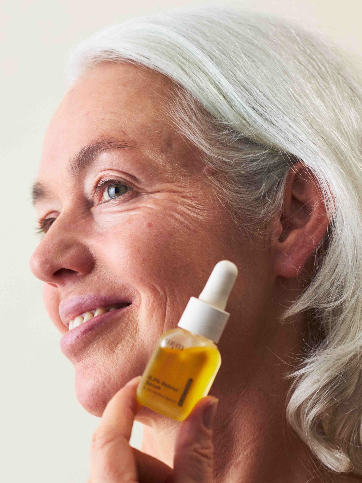 Eine Frau, die das 0,3% Retinol Serum in der Hand hält