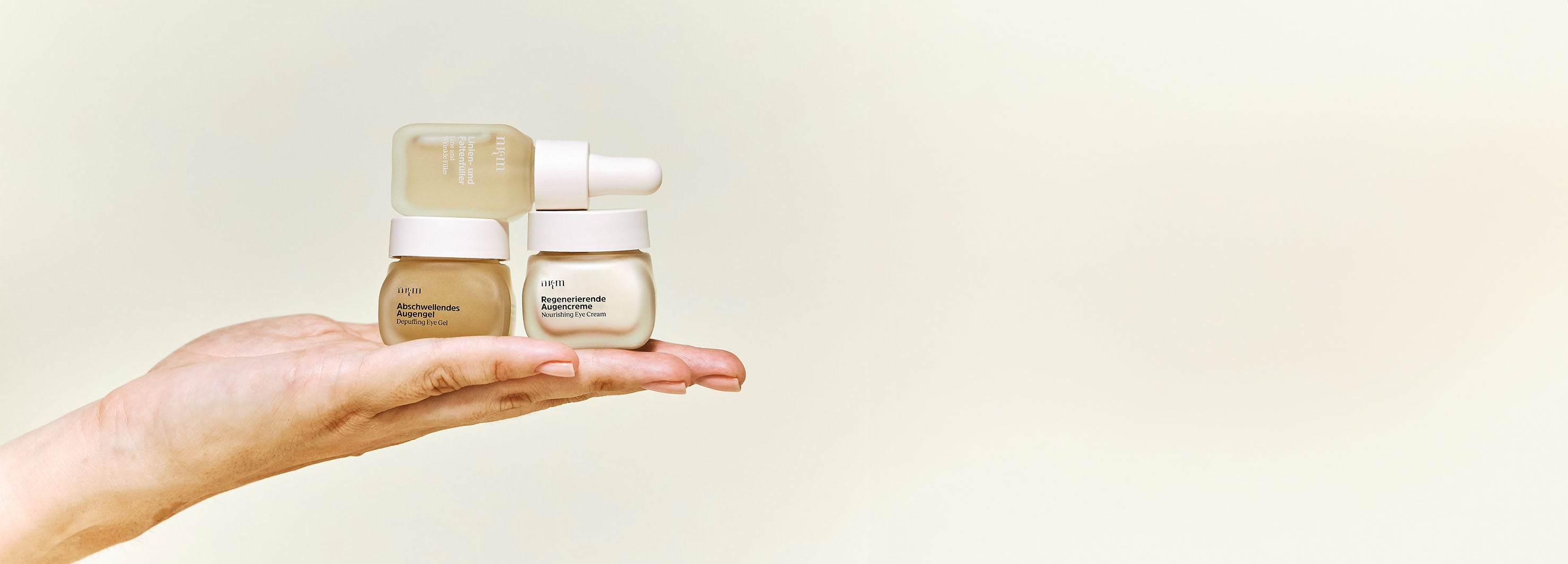 Linien- und Faltenfüller, Abschwellendes Augengel und Regenerierende Augencreme auf flacher Hand gelegt