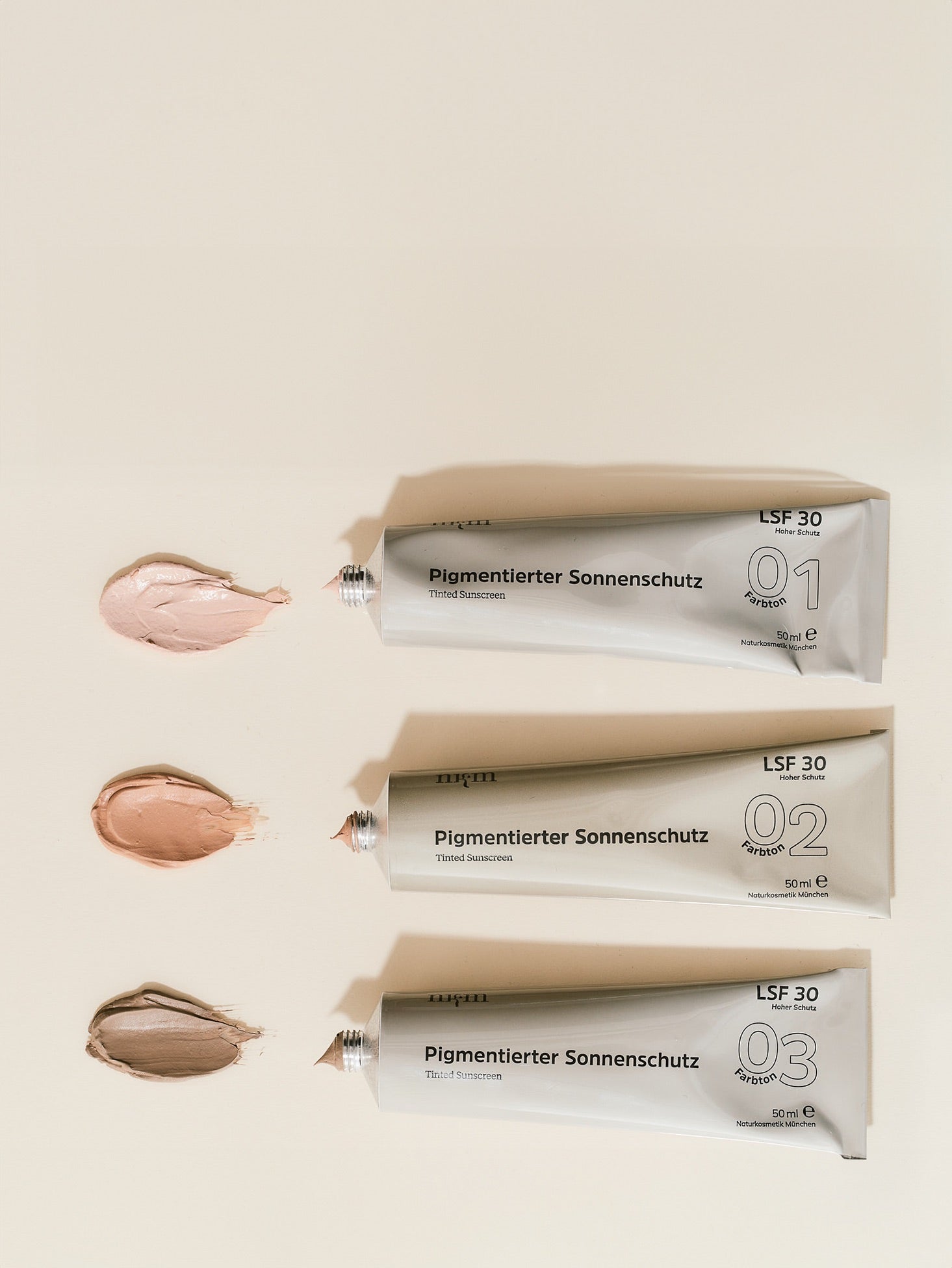 alle drei Pigmentierten Sonnenschutze in Tuben und aufgetragen