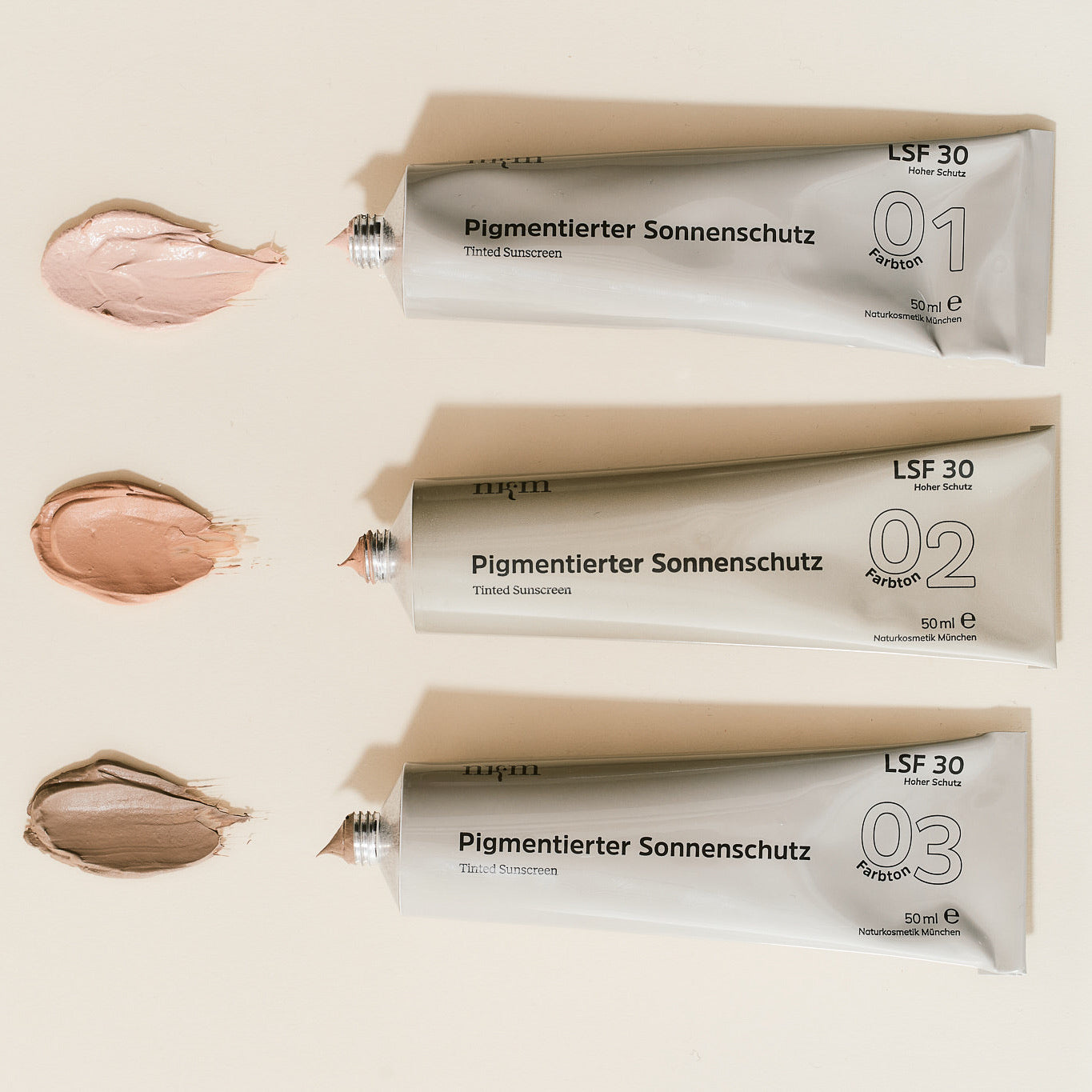 alle drei Pigmentierten Sonnenschutze in Tuben und aufgetragen