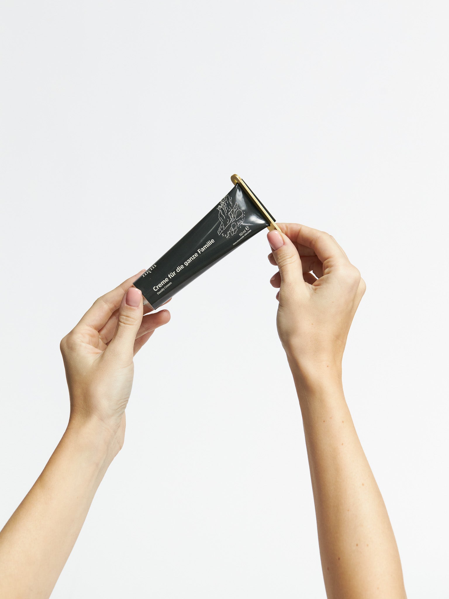 Creme für die ganze Familie und Tubenschlüssel in Anwendung