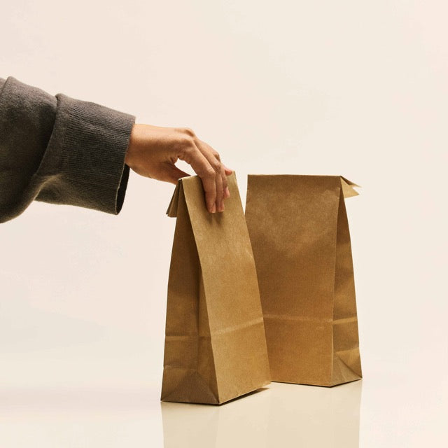 Überraschungstüten in braun die von einer Hand gehalten werden