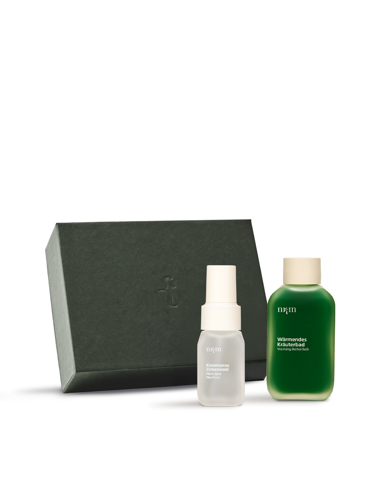 Grüne nkm Box mit Kissenspray Zirbenwald und Wärmendem Kräuterbad davor, vor transparentem Hintergrund